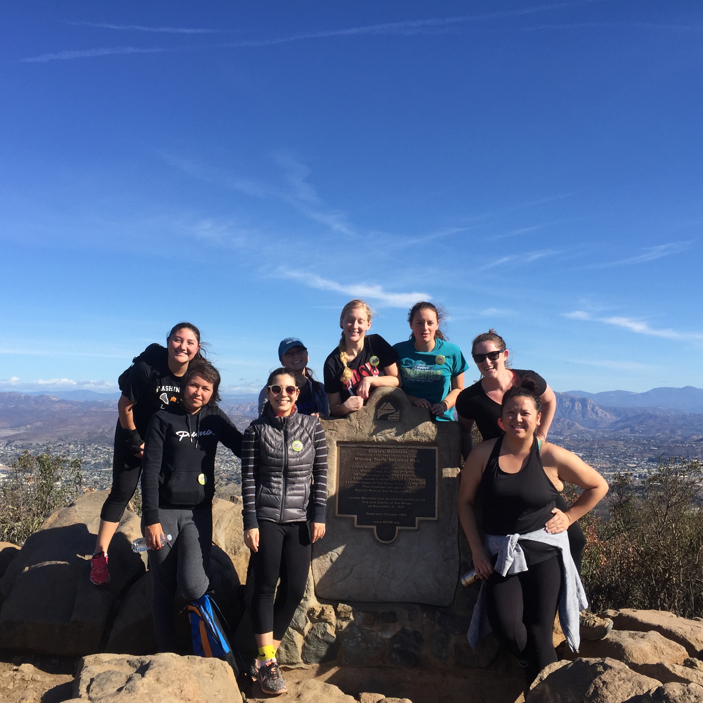 Group of Liberal Studies students and Michelle Xiong at the summit of Cowles Mountain, San Diego skyline in the background.