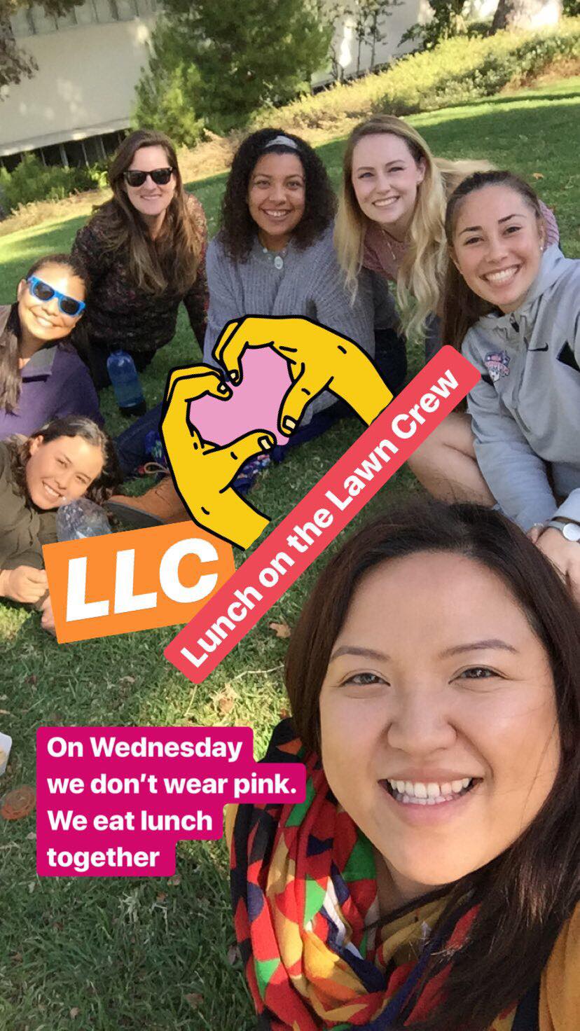 Students and Michelle Xiong at a Lunch on the Lawn Crew gathering, sitting together on the grass.